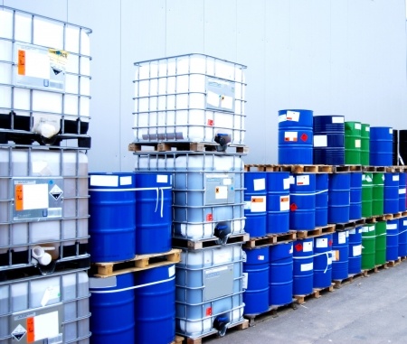 white container and blue drums on an industrial storage site